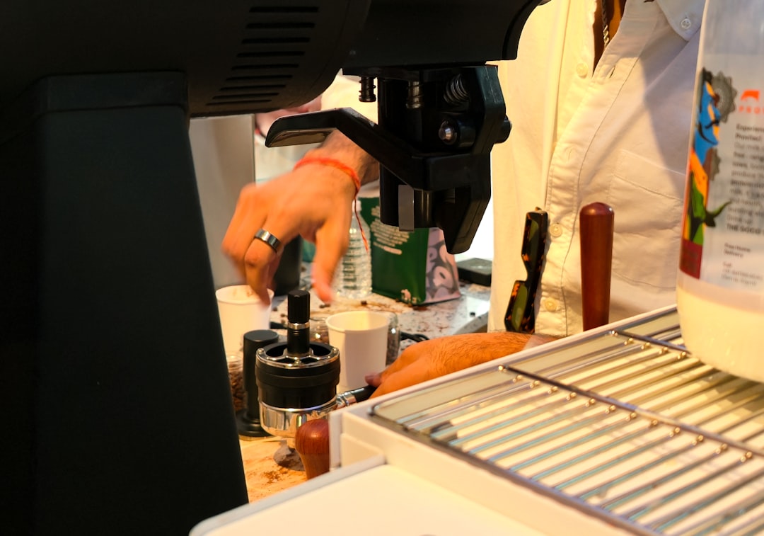 Barista preparing a drink at a coffee machine - Photo by Zoshua Colah on Unsplash